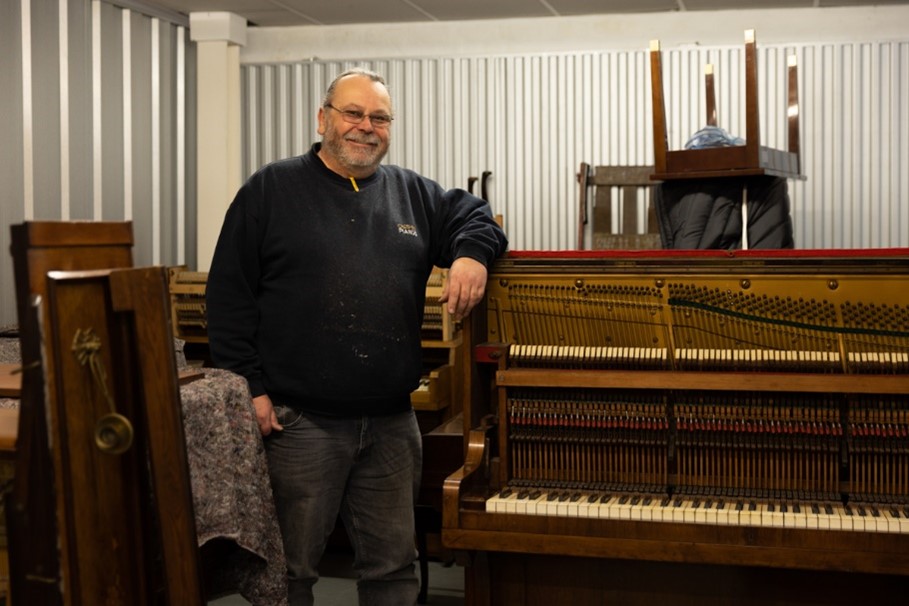 man from cheshire pianos in a storage unit