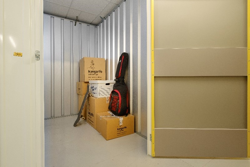 storage unit with boxes and guitar inside