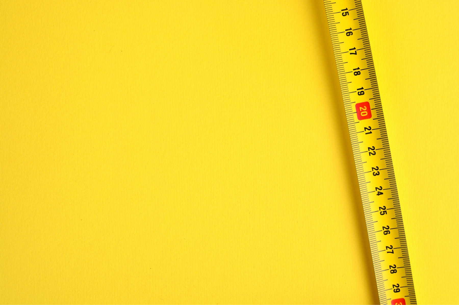 tape measure on a yellow background