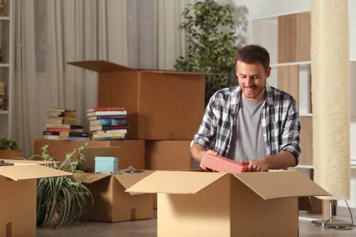 student packing boxes to move out