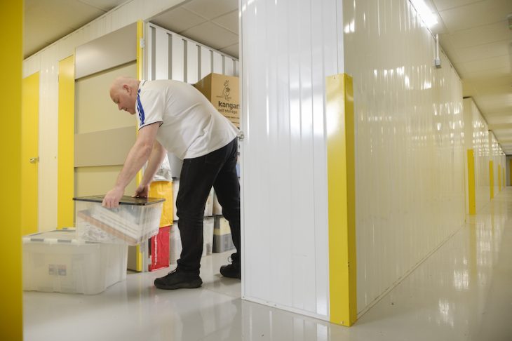 man loading boxes into storage unit