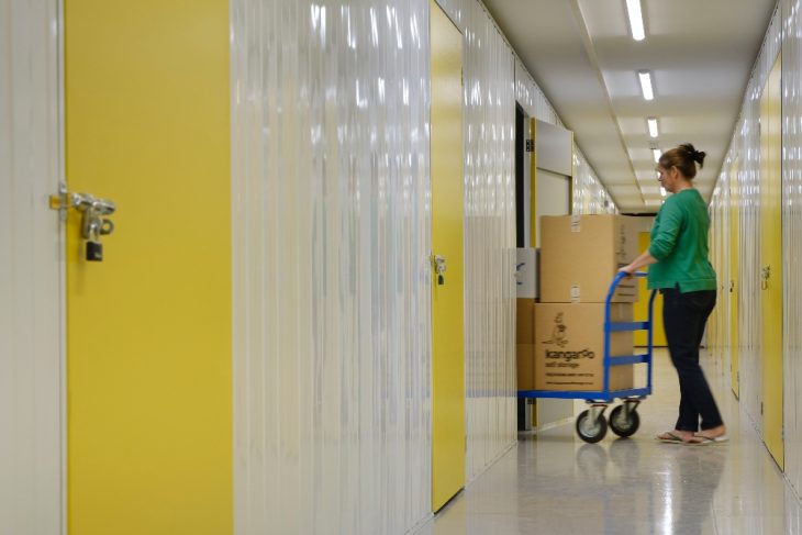 Woman loading business items into a business storage unit