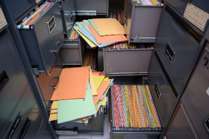 Overflowing filing cabinets