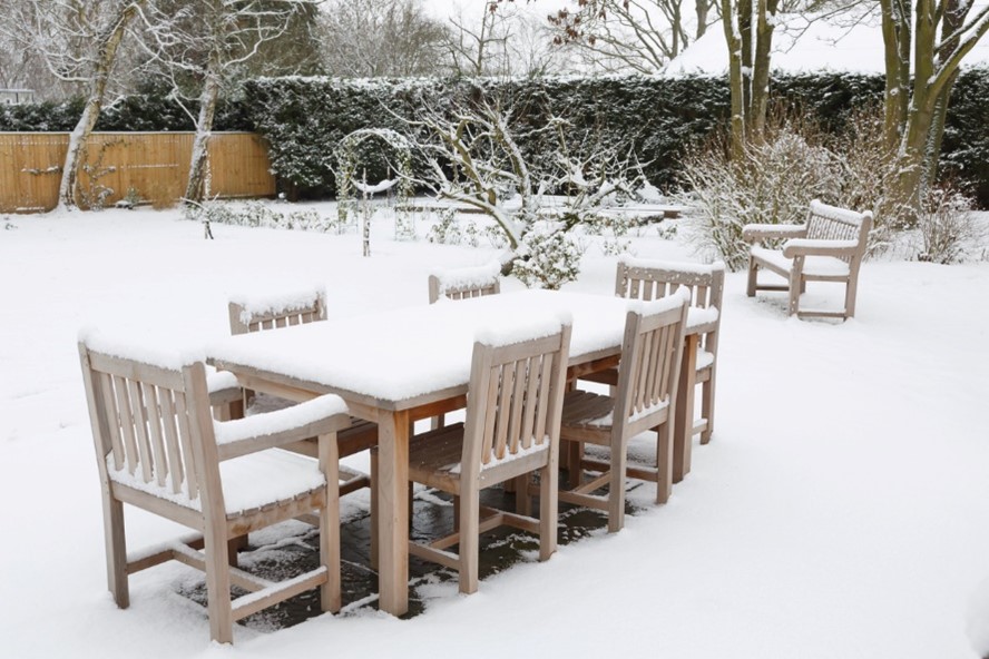 snow all over outdoor table and chairs