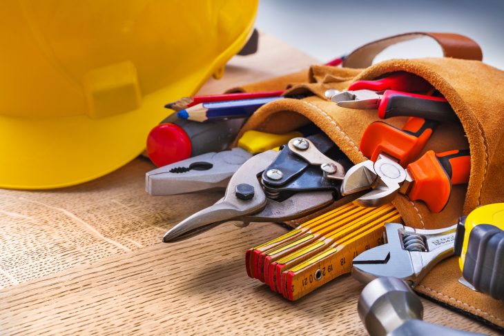 Construction tools and equipment on a wooden table