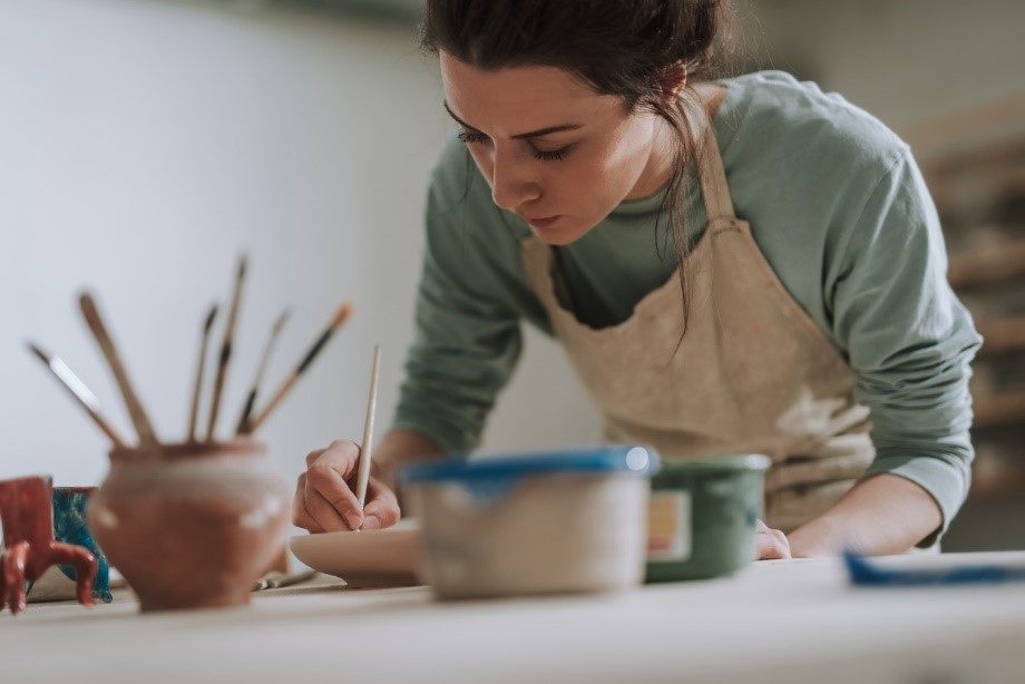 Woman painting inside a storage unit