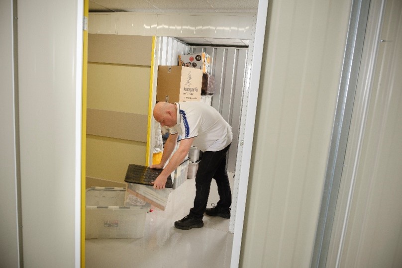 man packing a storage unit