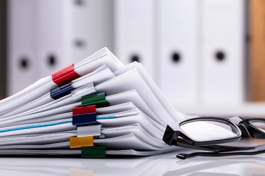 papers and glasses on a desk