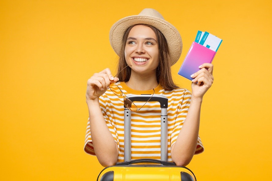 woman going on holiday holding passport