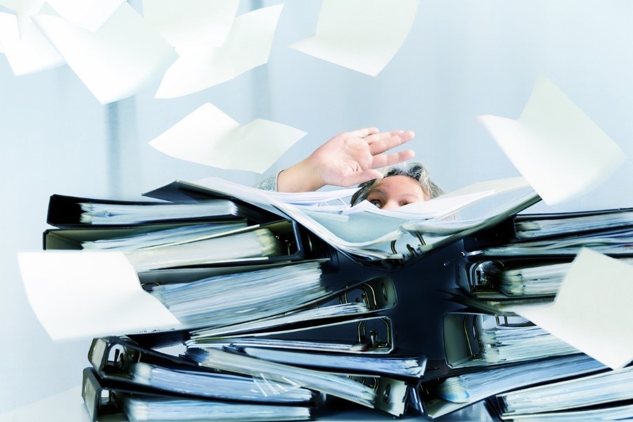 files piling up around person