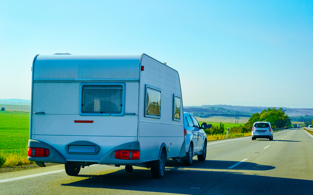 Car towing caravan on a road